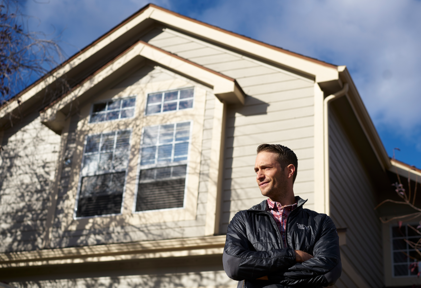 man standing in front of a house
